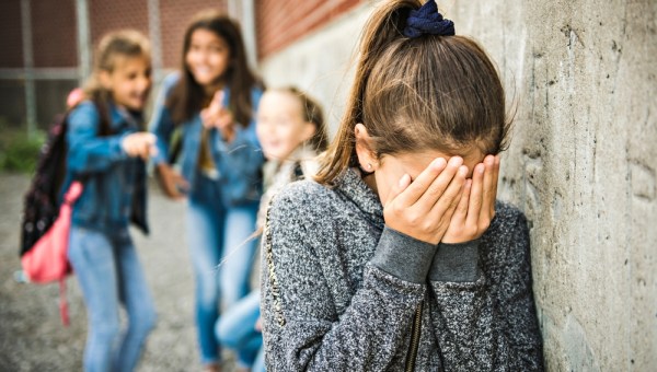 A sad girl intimidation moment on the elementary Age Bullying in Schoolyard