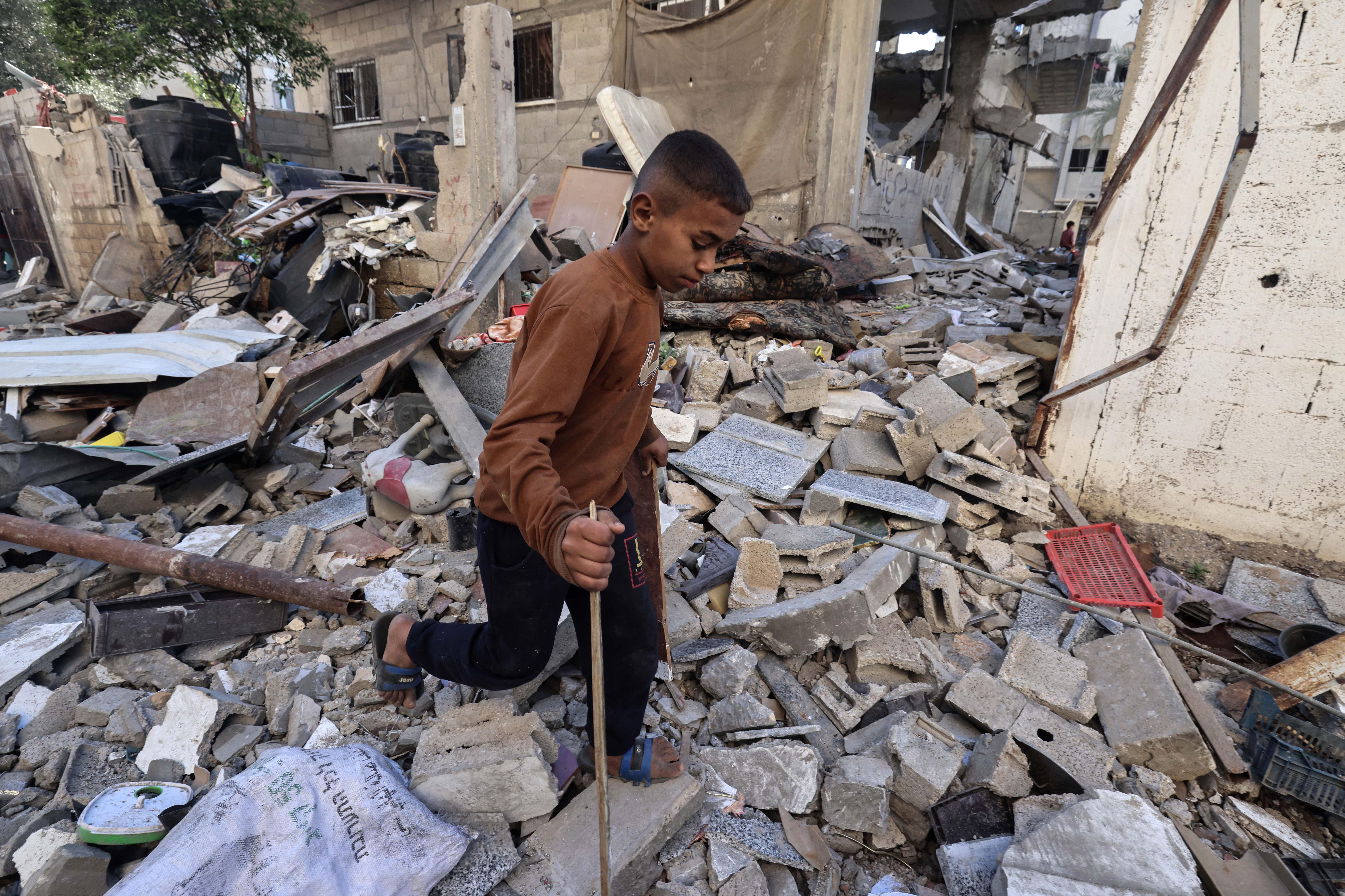Boy steps over rubble in Gaza