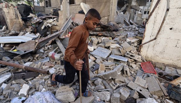 Boy steps over rubble in Gaza