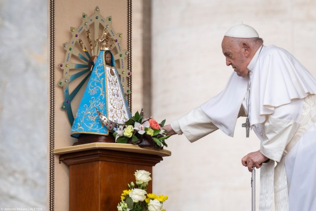 Pope Francis touches a statue of Our Lady of Lujan, during the weekly general audience on May 8, 2024 at St Peter's square in The Vatican.
