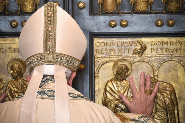 Pope Francis opens the Holy Door at St Peter's basilica to mark the start of the Jubilee Year of Mercy, on December 8, 2015 in Vatican.