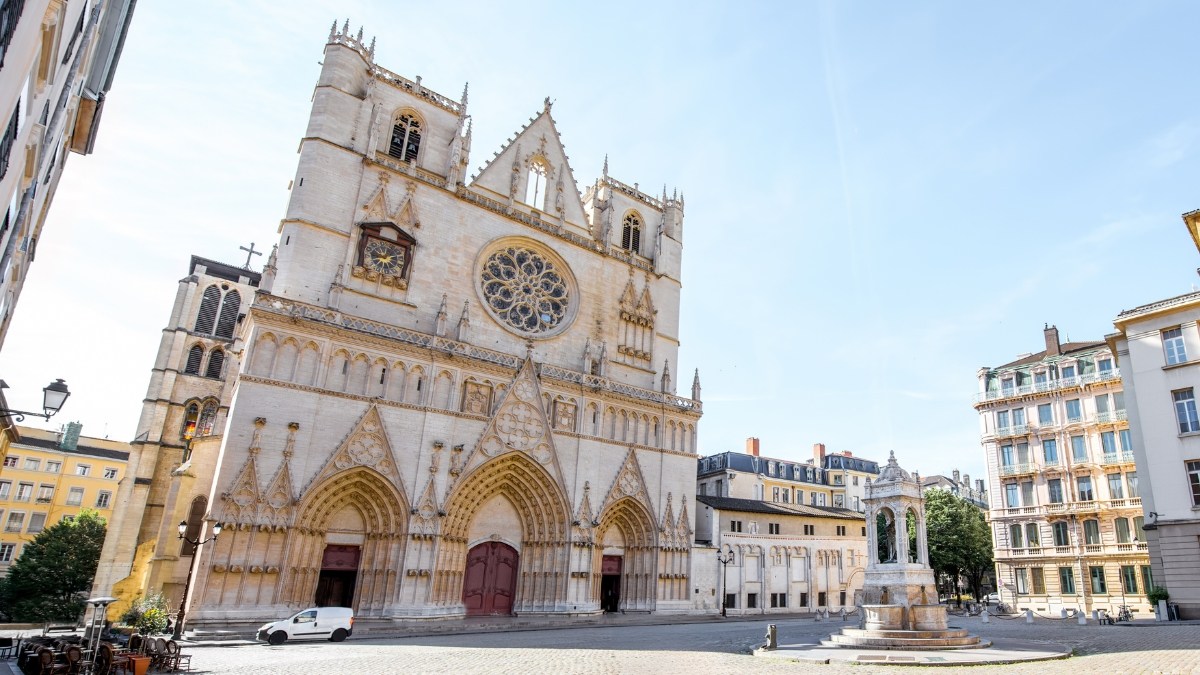 Morning view on the saint John cathedral with woman walking on the square in the old town of Lyon city