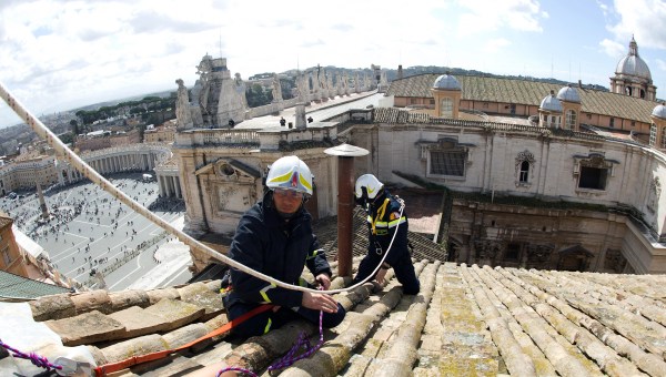 Vatican Press Office taken on March 9, 2013 shows Vatican's firefighters setting up the chimney on the roof of the Sistine chapel ahead of the cardinals conclave starting on March 12.