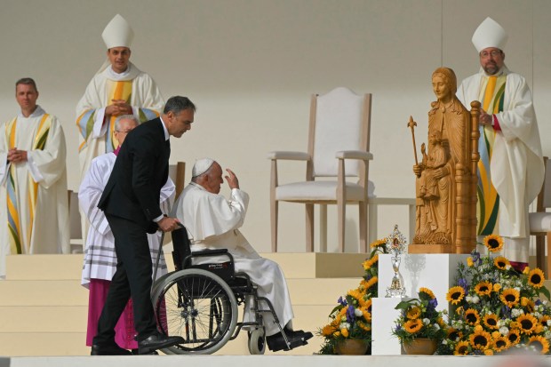 Pope Francis exits the stage on a wheelchair after a holy mass at King Badouin stadium, in Brussels on September 29, 2024.