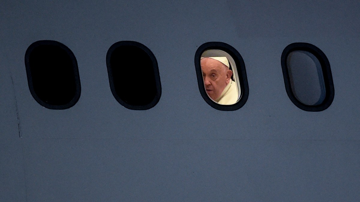 Pope Francis is seen through a window of the plane upon arrival at Port Moresby International airport on September 6, 2024.