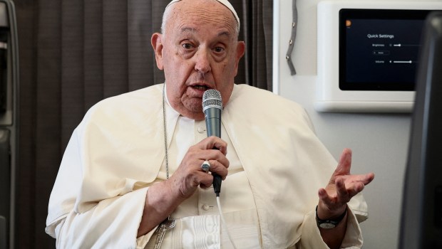 Pope Francis holds a news conference aboard the papal plane on his flight back after his 12-day journey across Southeast Asia and Oceania, on September 13, 2024.