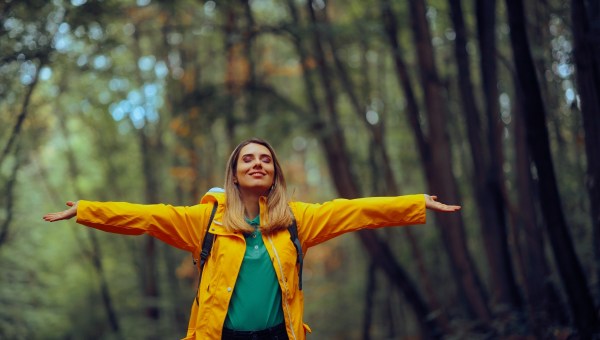 Happy Woman Enjoying the Forest During Spring Season