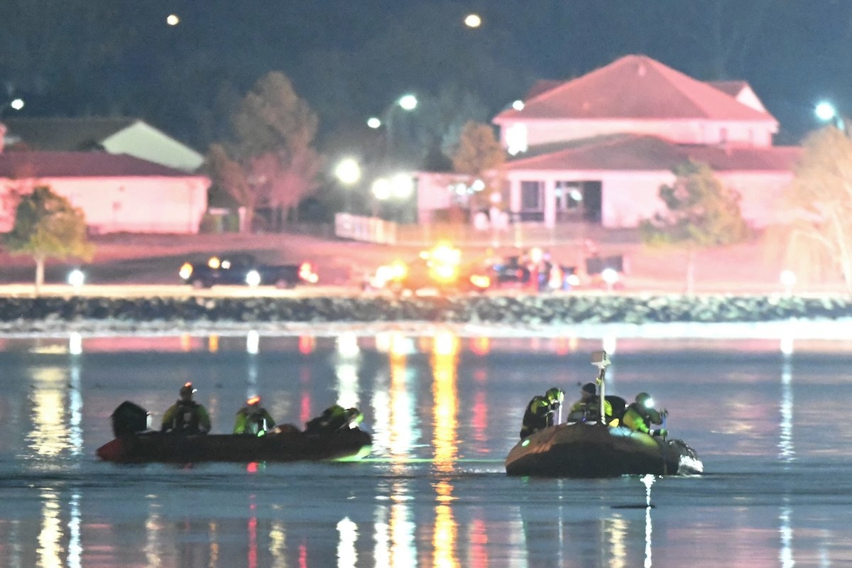 Rescue boats search the waters of the Potomac River after a plane on approach to Reagan National Airport crashed into the river outside Washington, DC, January 30, 2025.