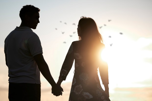 Couple, silhouette and holding hands at romantic, destination