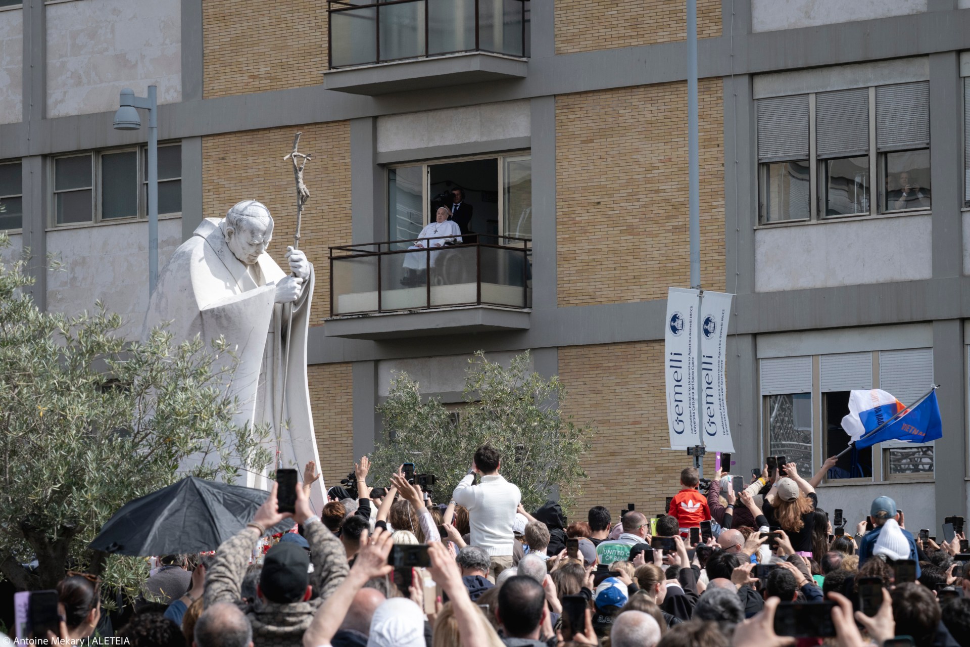 Pope Francis waves from a window of the Gemelli hospital before to be discharge after a five weeks hospitalization for pneumonia, in Rome on March 23, 2025