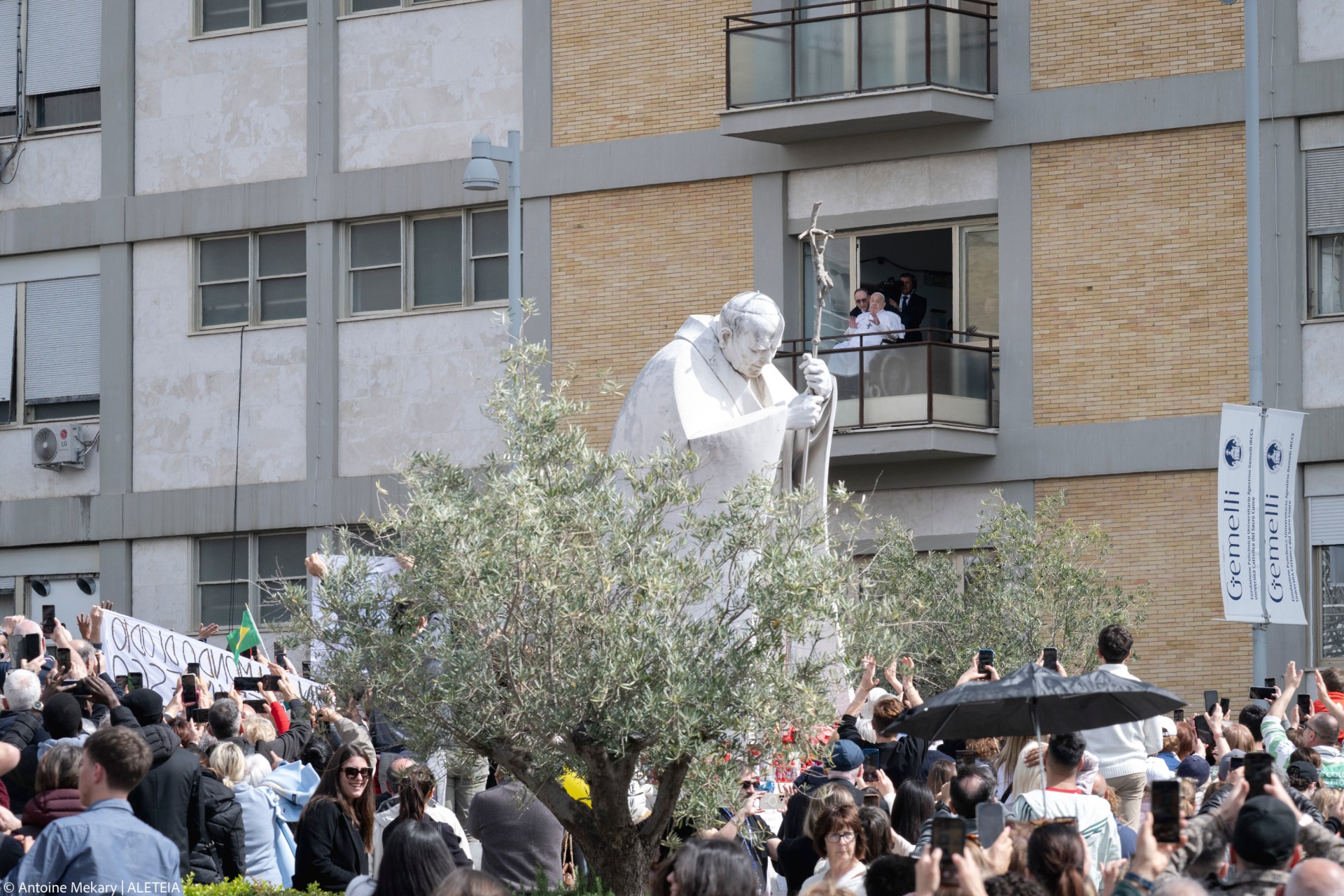 Pope Francis waves from a window of the Gemelli hospital before to be discharge after a five weeks hospitalization for pneumonia, in Rome on March 23, 2025