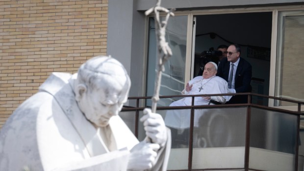 Pope Francis waves from a window of the Gemelli hospital before to be discharge after a five weeks hospitalization for pneumonia, in Rome on March 23, 2025
