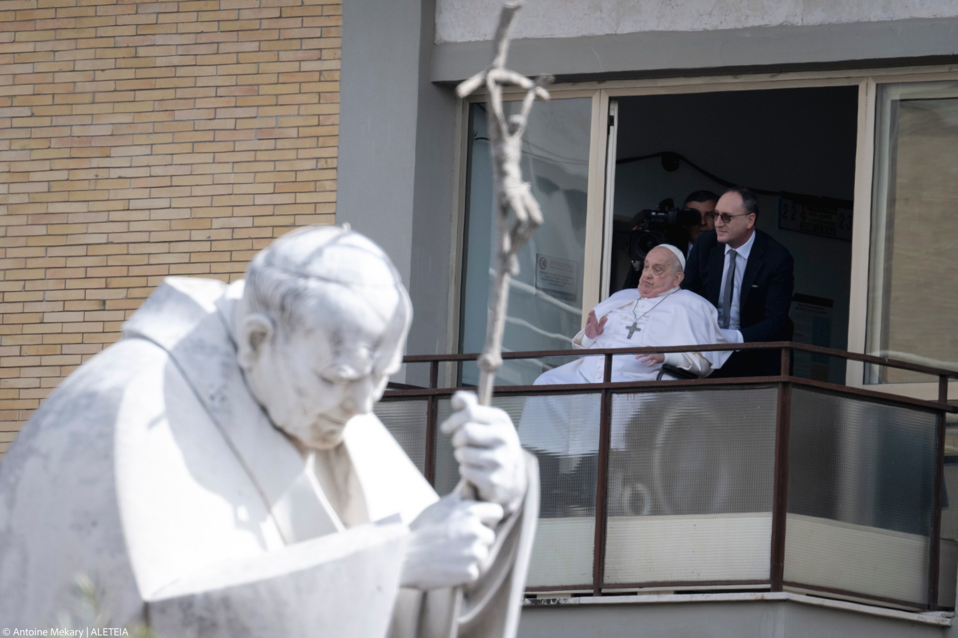 Pope Francis waves from a window of the Gemelli hospital before to be discharge after a five weeks hospitalization for pneumonia, in Rome on March 23, 2025