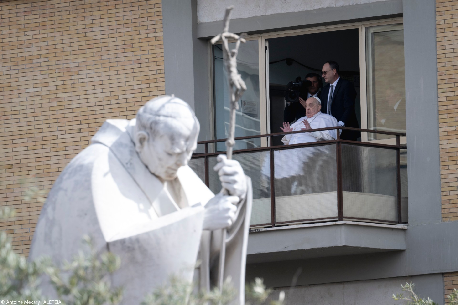 Pope Francis waves from a window of the Gemelli hospital before to be discharge after a five weeks hospitalization for pneumonia, in Rome on March 23, 2025