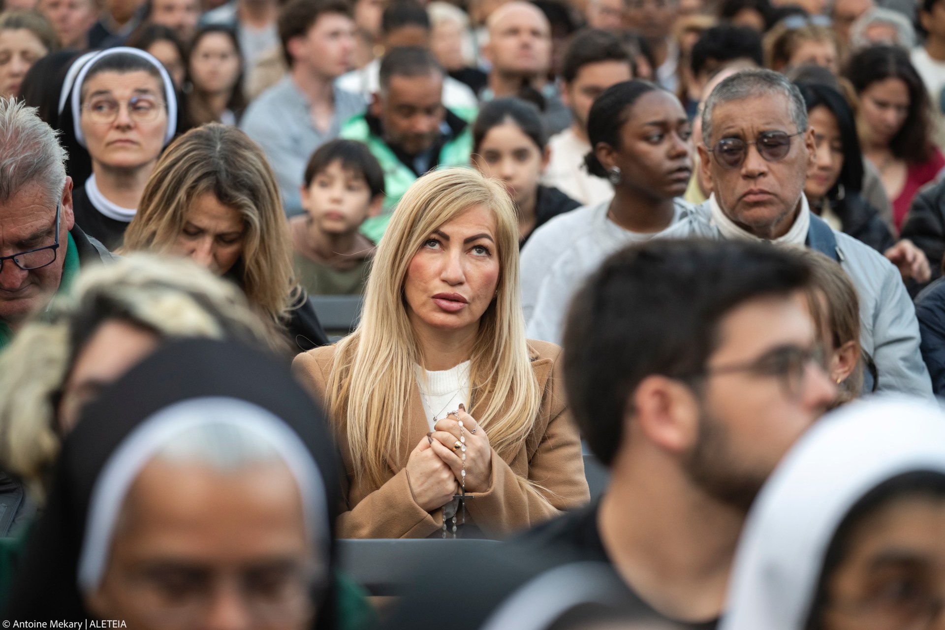Devotees attend a Rosary in homage to Pope Francis following his death in Saint Peter's Square, the Vatican, on April 21, 2025